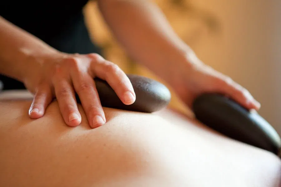 Heated stones used for grounding warmth and muscle relaxation in sessions